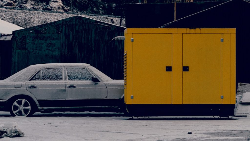 a-car-parked-next-to-a-yellow-trailer-8i6s8h6xlq8